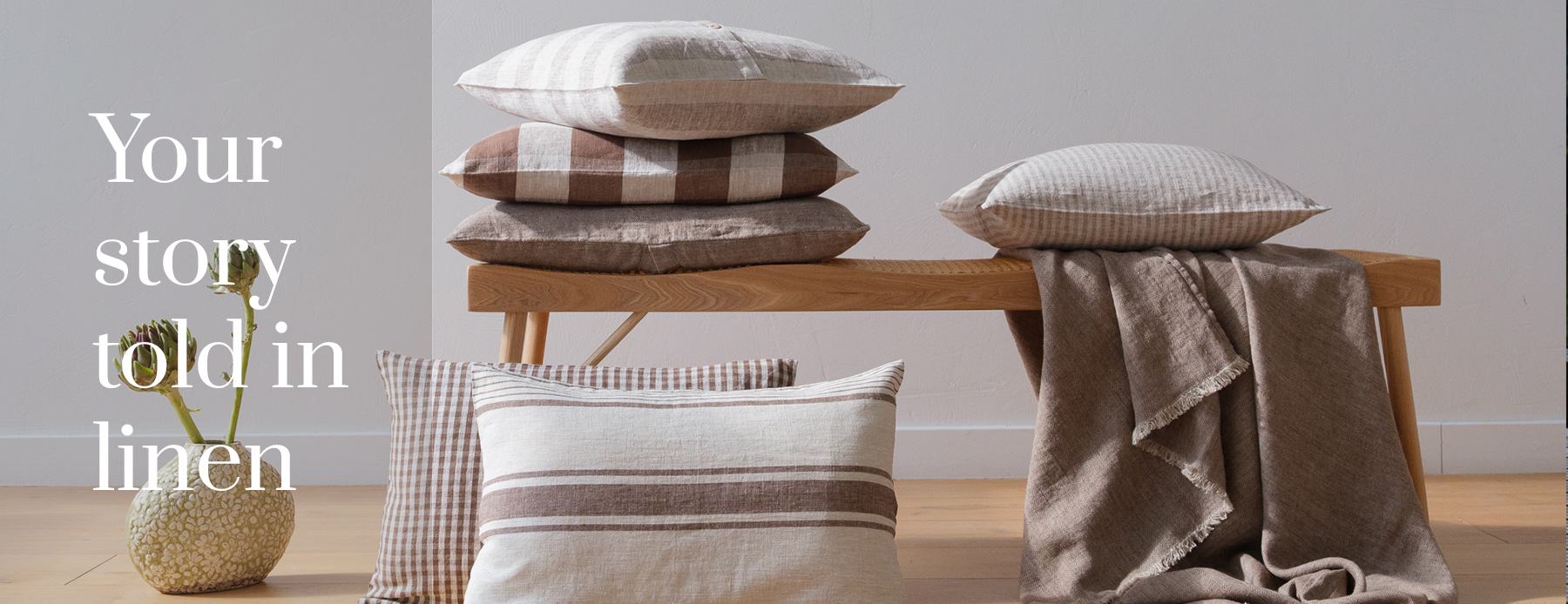 Your story told in linen — striped and checked linen cushions with a natural linen throw.