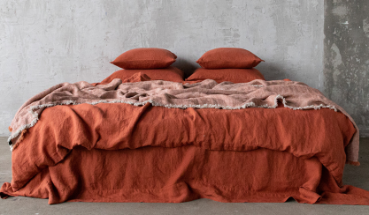 Brick-coloured linen bedding styled for an autumn bedroom