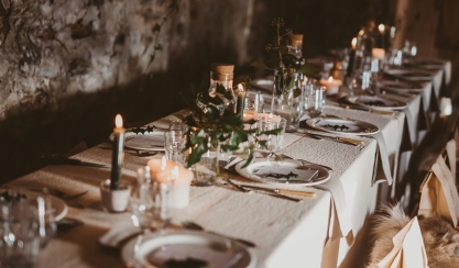 Festive dining table styled with striped linen tablecloth and napkins
