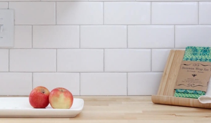 Beeswax wrap beside two apples on a kitchen counter