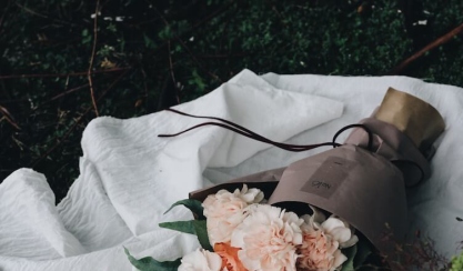 Bouquet resting on a white linen tablecloth