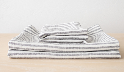 Folded grey-striped linen huckaback towels