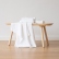 Optical-white Waffle linen towels folded on a wooden bench