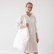 Woman carrying an off-white Terra linen shopping bag over her shoulder